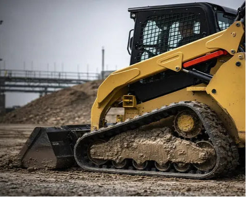 compact track loader equipped with heavy-duty aftermarket tracks – contractor-rated durability – installed view